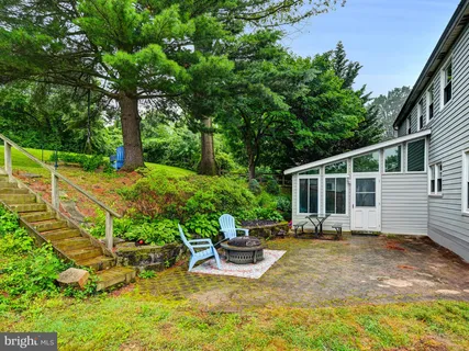 a view of a house with backyard sitting area and garden