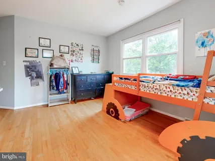 a room with a bed and a large window