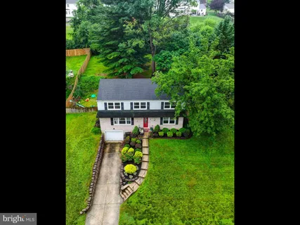 a aerial view of a house with swimming pool garden and patio