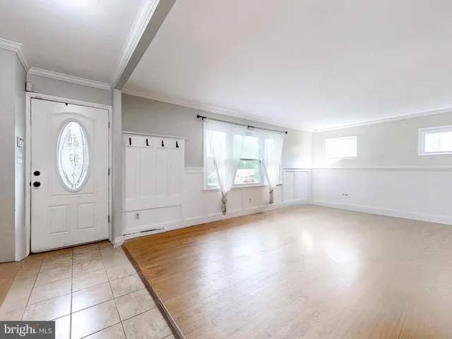 an empty room with windows and entrance