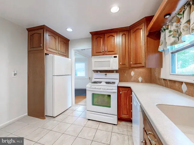 a kitchen with stainless steel appliances granite countertop a refrigerator sink and stove