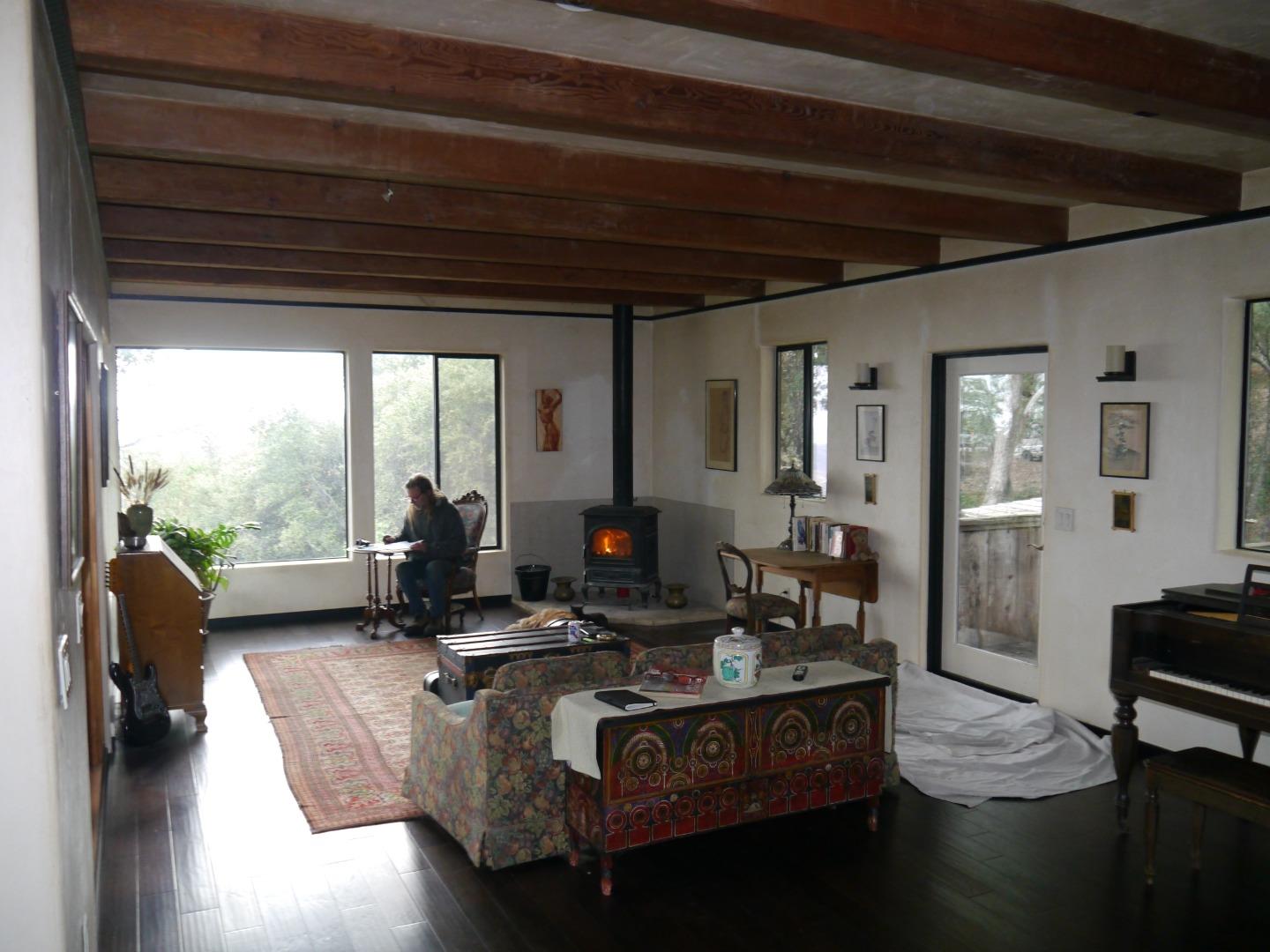 39450 Tassajara Road Carmel Valley, CA 93924 - Photo 15 of 61 a living room with furniture gym equipment and a large window
