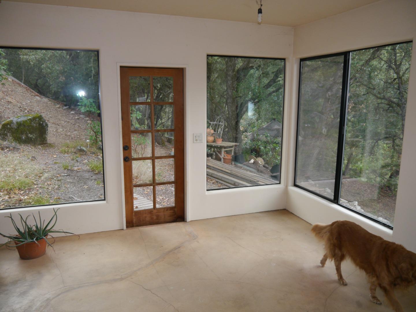 39450 Tassajara Road Carmel Valley, CA 93924 - Photo 26 of 61 a view of an empty room with windows and a balcony