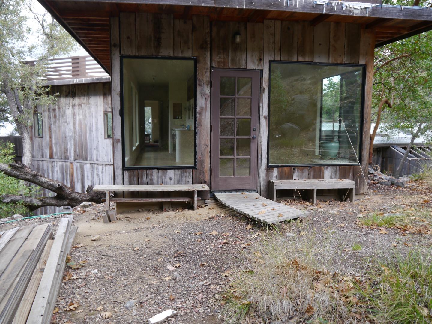 39450 Tassajara Road Carmel Valley, CA 93924 - Photo 45 of 61 a view of a house with a yard and wooden fence