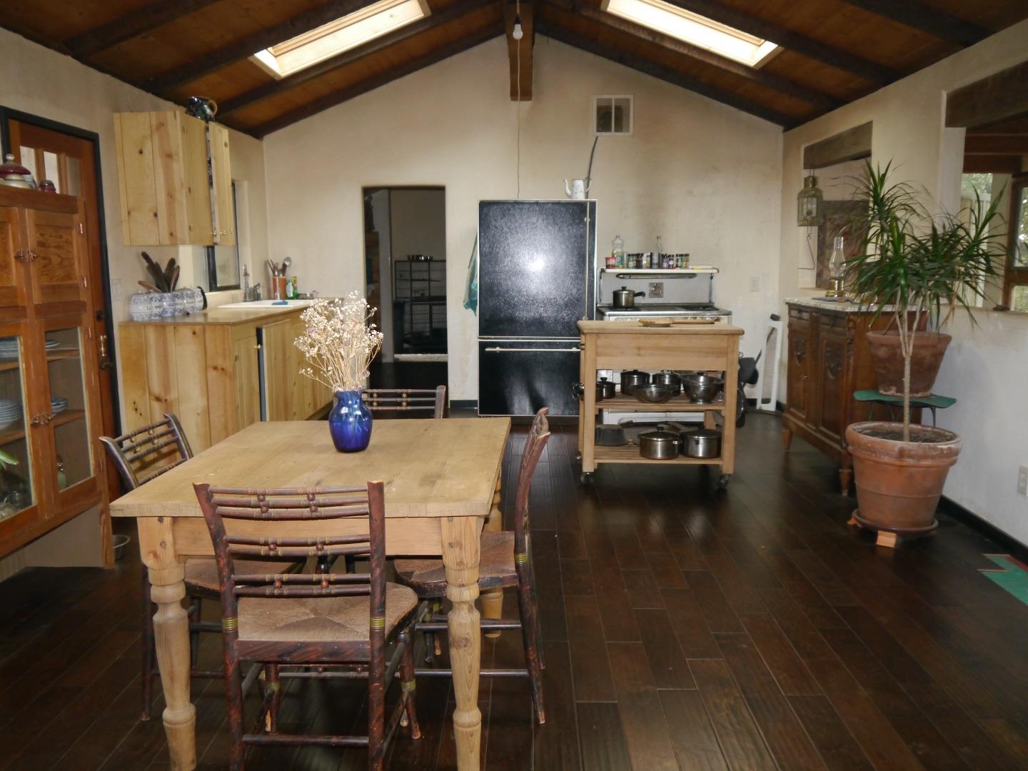 39450 Tassajara Road Carmel Valley, CA 93924 - Photo 8 of 61 a kitchen with a table chairs stove and cabinets