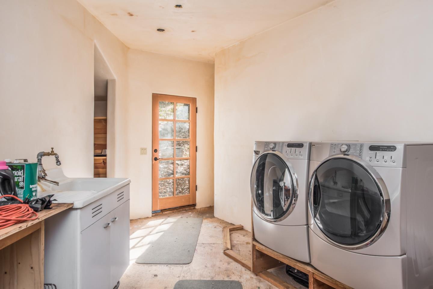 39450 Tassajara Road Carmel Valley, CA 93924 - Photo 10 of 61 a utility room with sink dryer and washer