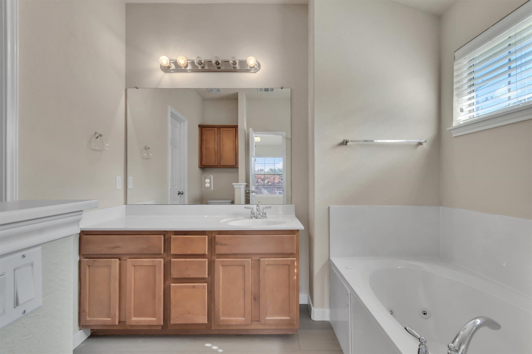 14815 Avery Ranch Boulevard, Unit 2A Austin, TX 78717 - Photo 17 of 27 A well-lit primary bath features a vanity with ample storage and a relaxing built-in tub.