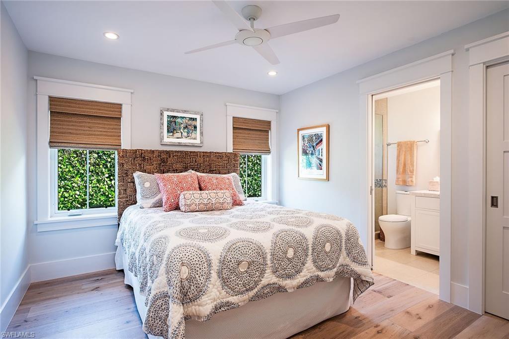 370 Rudder Road Naples, FL 34102 - Photo 12 of 26 a bedroom with a large bed and a window