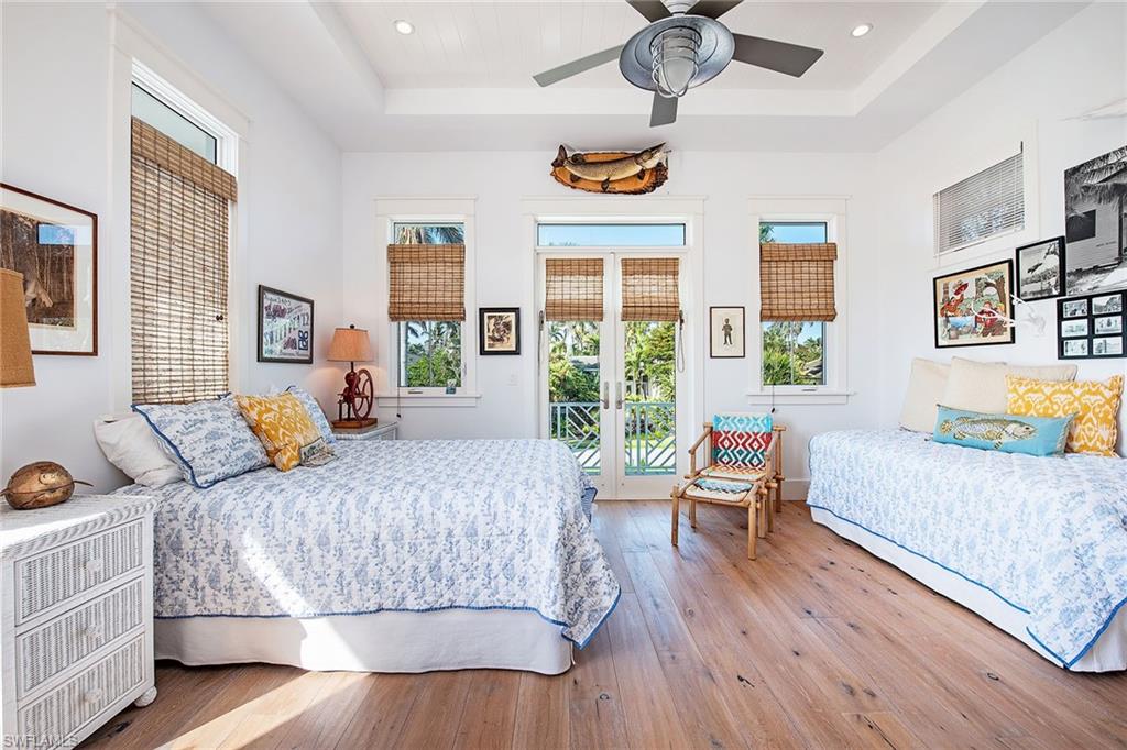 370 Rudder Road Naples, FL 34102 - Photo 20 of 26 a bedroom with a bed and a large window