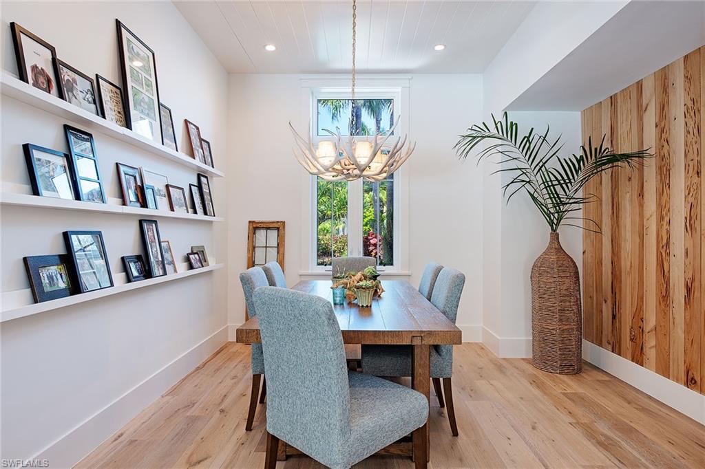 370 Rudder Road Naples, FL 34102 - Photo 5 of 26 a view of a dining room with furniture window and wooden floor