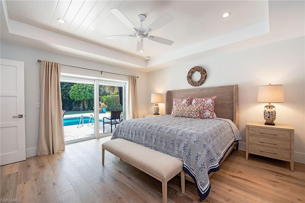 370 Rudder Road Naples, FL 34102 - Photo 10 of 26 a bedroom with a large bed and a window