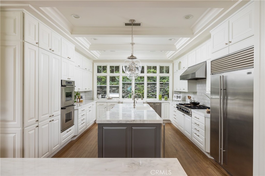 56 Royal St George Road Newport Beach, CA 92660 - Photo 15 of 49 a kitchen with a center island wooden floor and stainless steel appliances