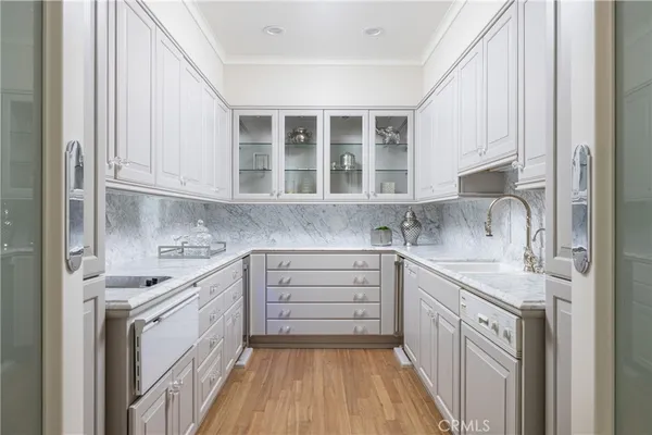 a kitchen with a sink stove and cabinets