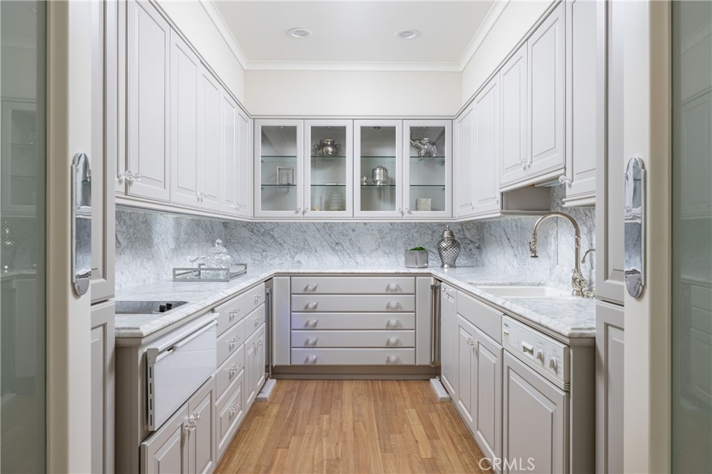 56 Royal St George Road Newport Beach, CA 92660 - Photo 18 of 49 a kitchen with a sink stove and cabinets