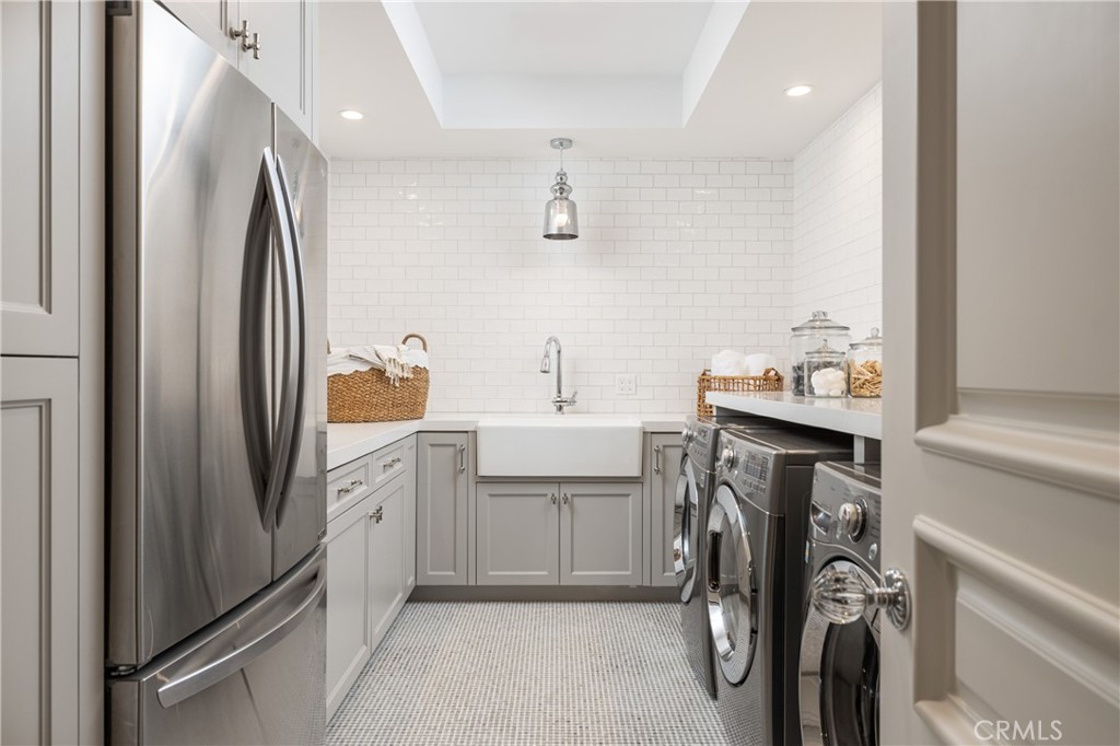 56 Royal St George Road Newport Beach, CA 92660 - Photo 20 of 49 a kitchen with a refrigerator and washing machine