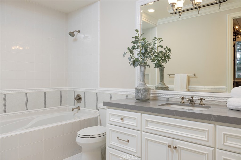 56 Royal St George Road Newport Beach, CA 92660 - Photo 28 of 49 a bathroom with a granite countertop sink a toilet and bathtub