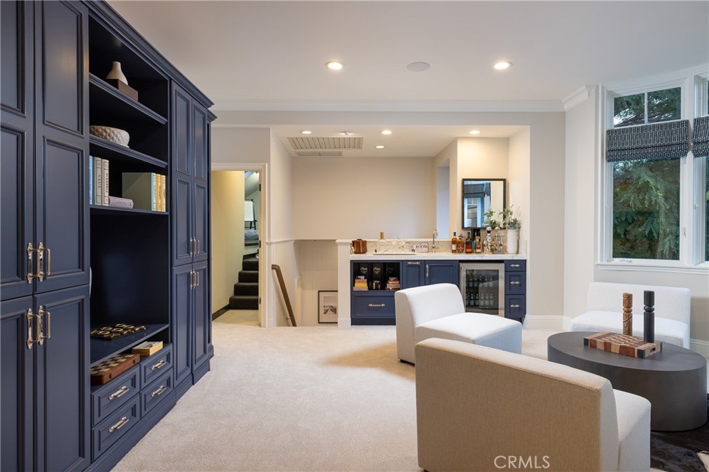 56 Royal St George Road Newport Beach, CA 92660 - Photo 31 of 49 a living room with furniture a flat screen tv and a floor to ceiling window
