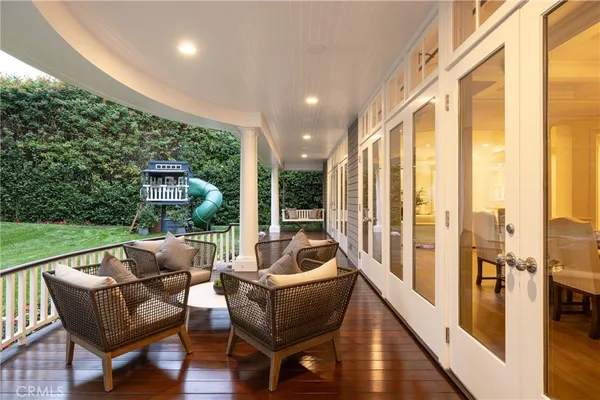 a balcony with furniture and a garden