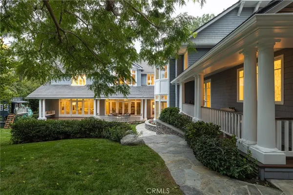 a front view of a house with a yard and porch
