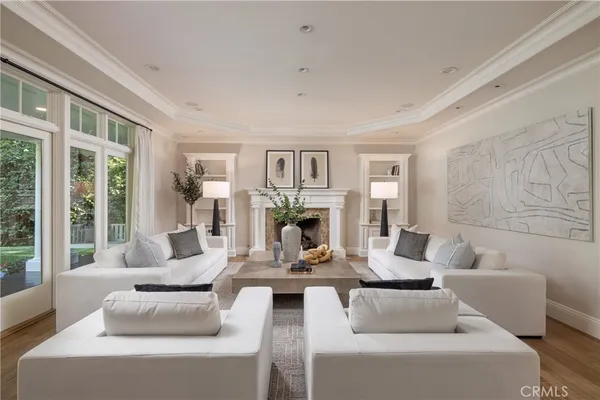 a living room with fireplace furniture and a large window