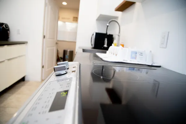 a close view of a sink and living room with furniture