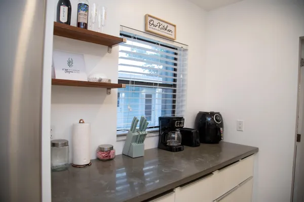 a kitchen with a sink a stove and cabinets