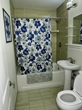 a bathroom with a toilet and shower
