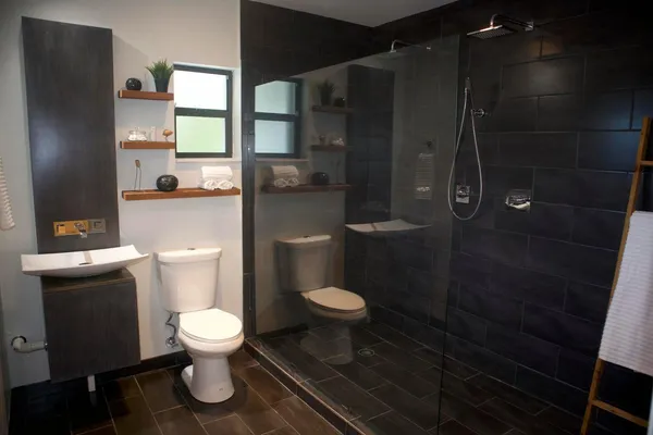 a white toilet sitting next to a bathroom sink