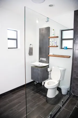 a bathroom with a toilet sink and mirror