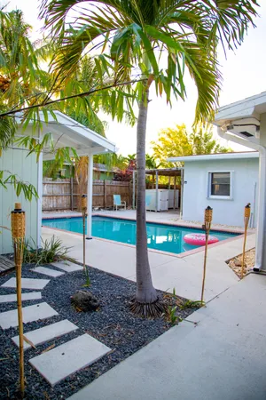 a view of a house with backyard and tree