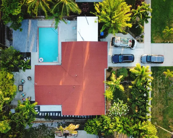 an aerial view of a house with a garden and swimming pool