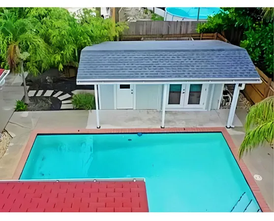 a aerial view of a house with a yard table and chairs