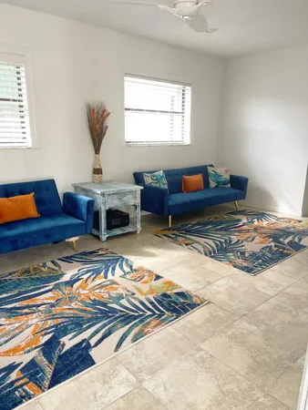 a living room with furniture rug and window