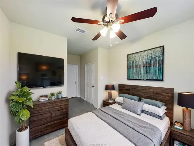 a bedroom with a bed and a flat screen tv