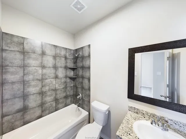 a bathroom with a bathtub and a sink