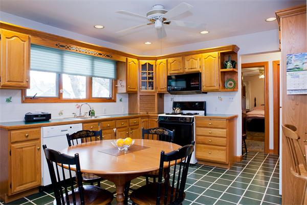 14 Clark Road Newton, MA 02465 - Photo 4 of 6 a kitchen with stainless steel appliances granite countertop a stove a refrigerator a kitchen island a dining table and chairs