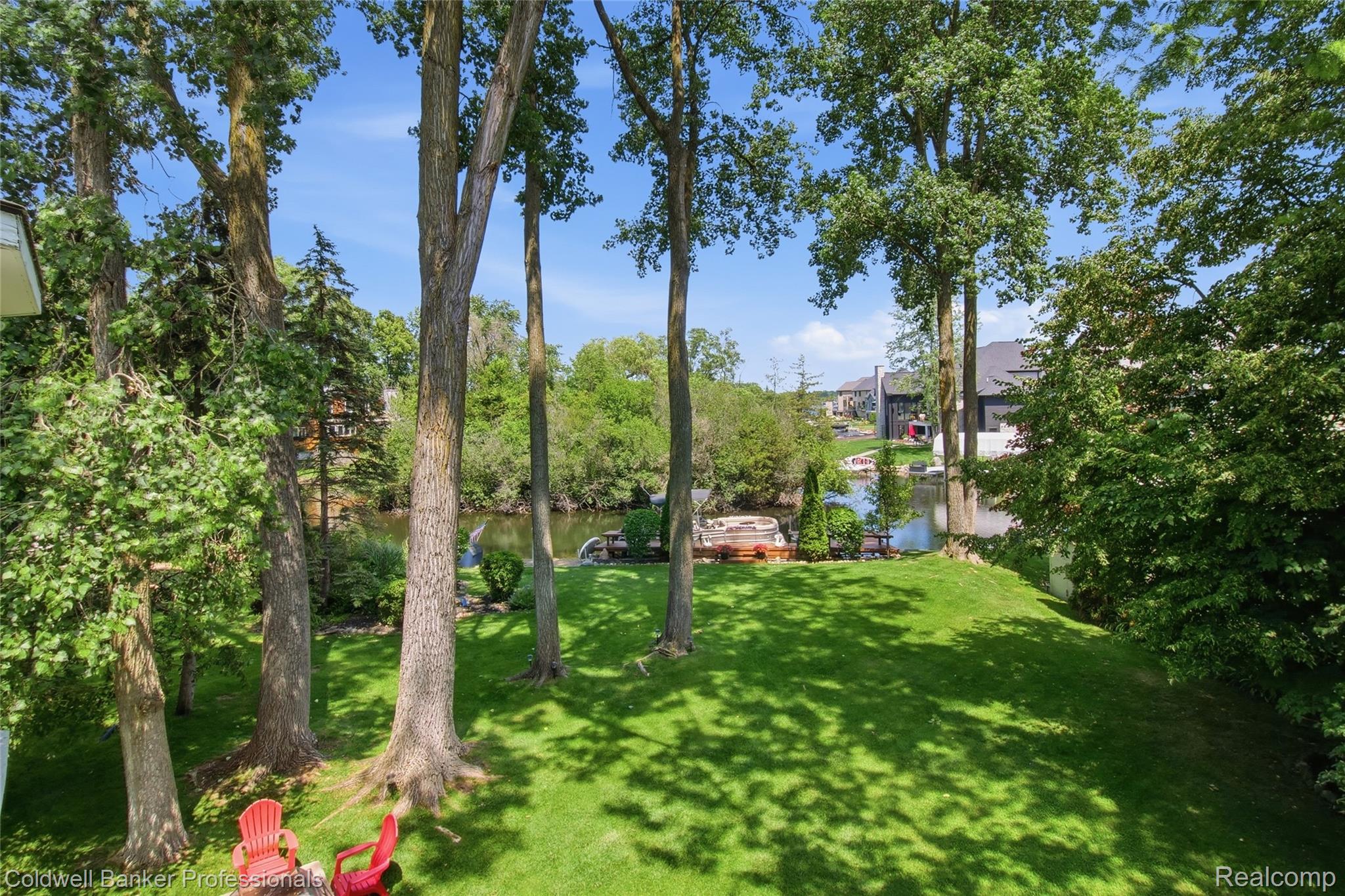 3410 Benstein Road Commerce Township, MI 48382 - Photo 41 of 45 Grassy yard featuring mature deciduous trees and a tranquil waterway