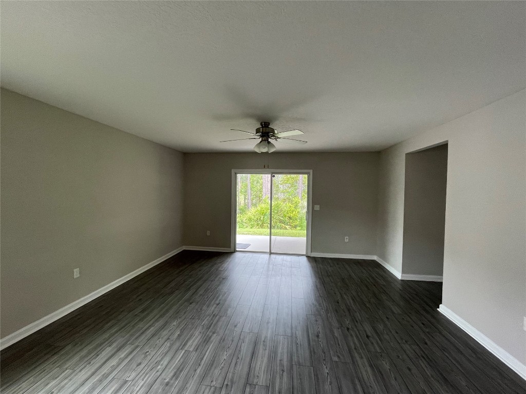 77444 Lumber Creek Boulevard Yulee, FL 32097 - Photo 11 of 24 wooden floor in an empty room with a window