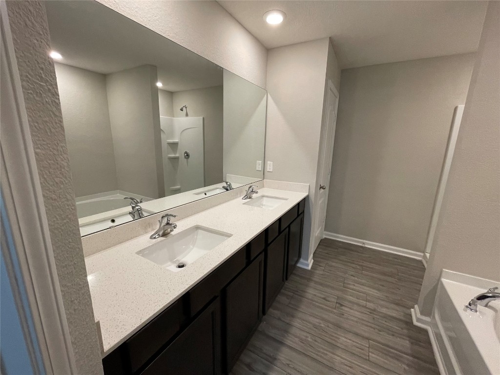 77444 Lumber Creek Boulevard Yulee, FL 32097 - Photo 17 of 24 a spacious bathroom with a double vanity sink and mirror