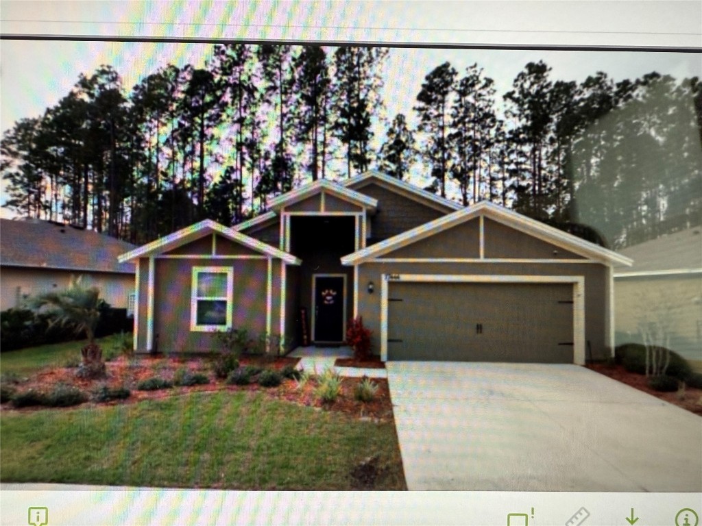 77444 Lumber Creek Boulevard Yulee, FL 32097 - Photo 24 of 24 a front view of a house with a yard