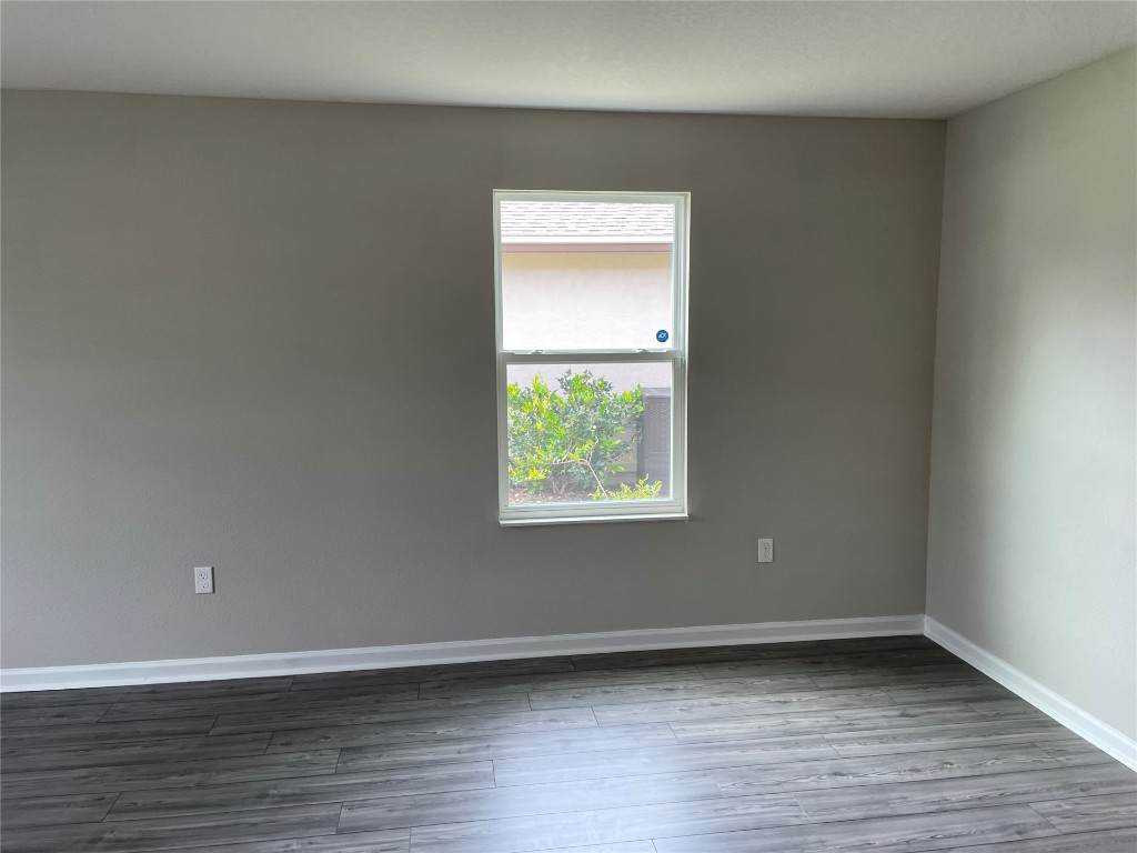 77444 Lumber Creek Boulevard Yulee, FL 32097 - Photo 3 of 24 a view of an empty room with wooden floor and a window