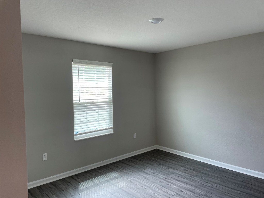 77444 Lumber Creek Boulevard Yulee, FL 32097 - Photo 4 of 24 an empty room with wooden floor and windows