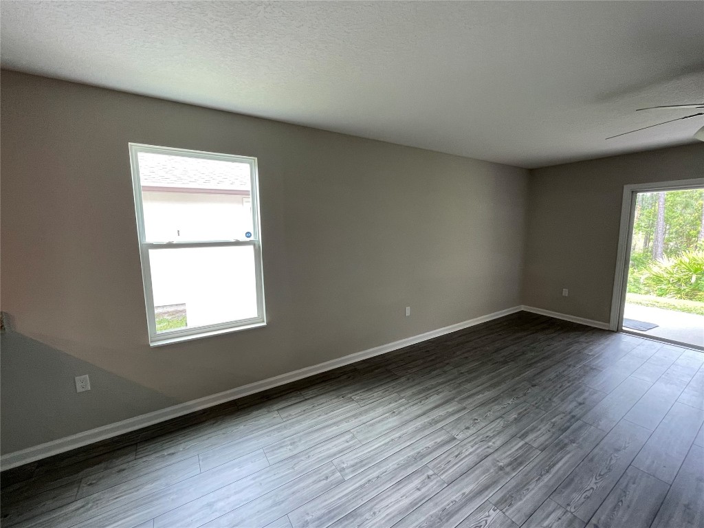 77444 Lumber Creek Boulevard Yulee, FL 32097 - Photo 10 of 24 an empty room with wooden floor and windows