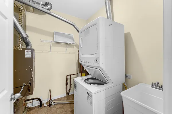 a bathroom with a sink and a washer dryer