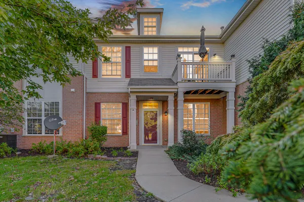 front view of a brick house with a yard