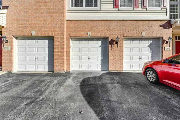 a front view of a house with a parking space