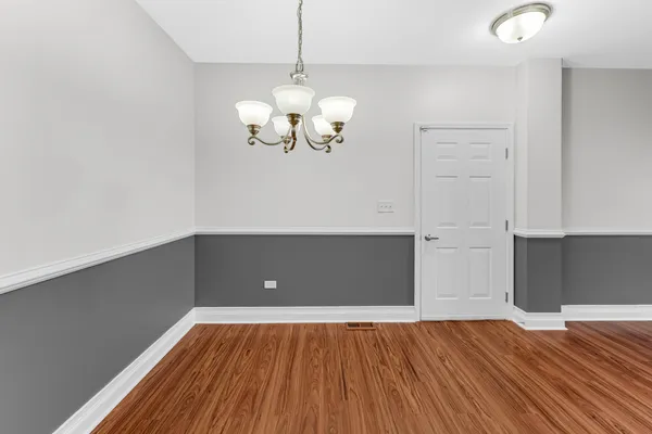 a view of room with wooden floor