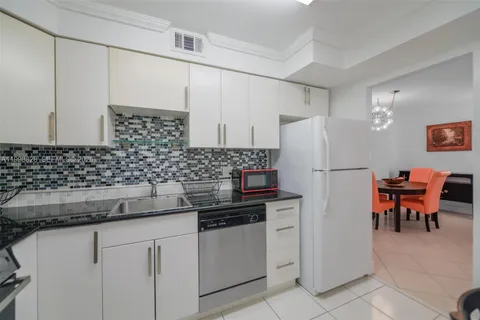 a kitchen with stainless steel appliances a refrigerator sink and cabinets