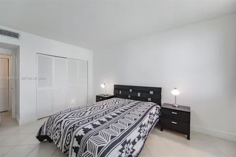a bedroom with a bed and a closet