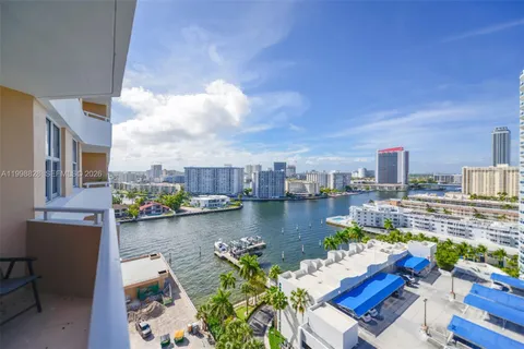a view of a lake with couches and city view